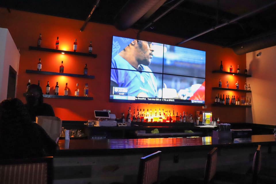 Bar with a screen at GOAT Sports Lounge