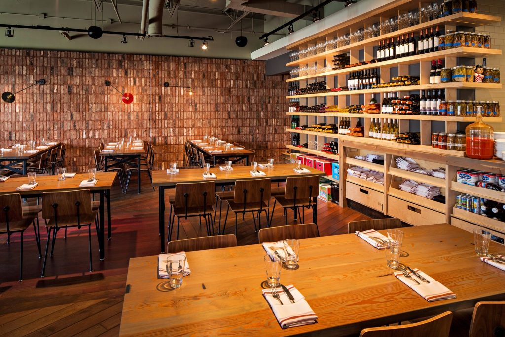 Rustic style restaurant with brick walls and earth toned furniture at Seven Lamps