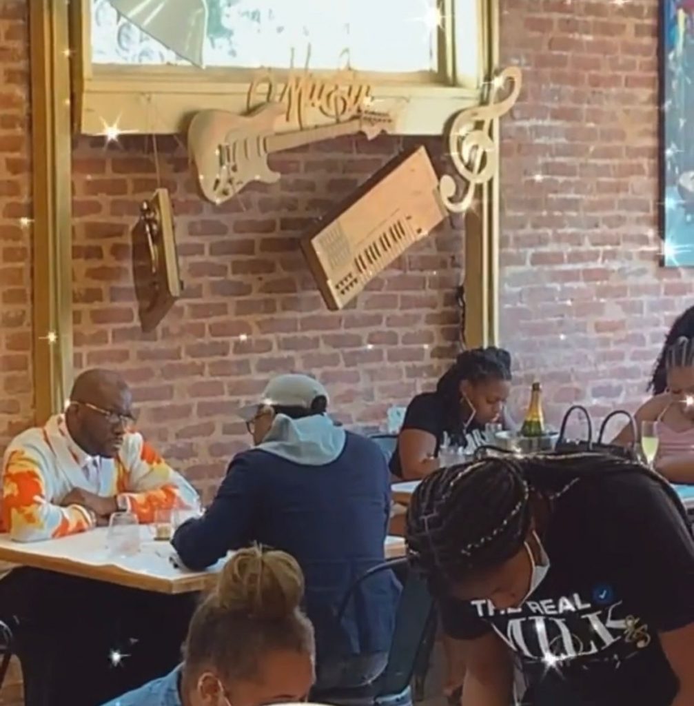 Patrons seated at tables in a restaurant with brick walls at The Real Milk & Honey