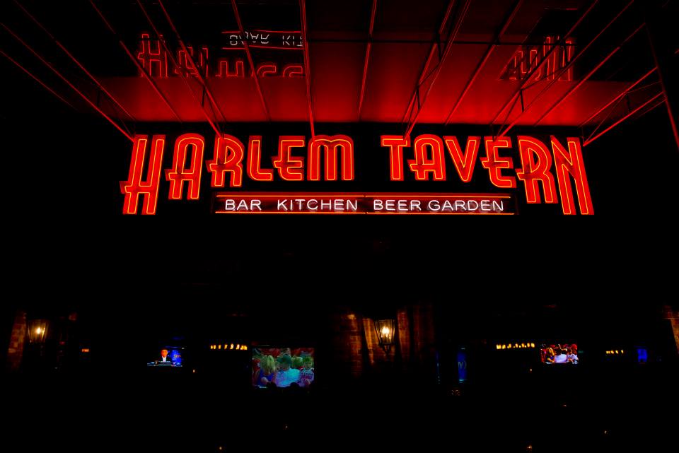Harlem Tavern sign lighted up in red at Harlem Tavern