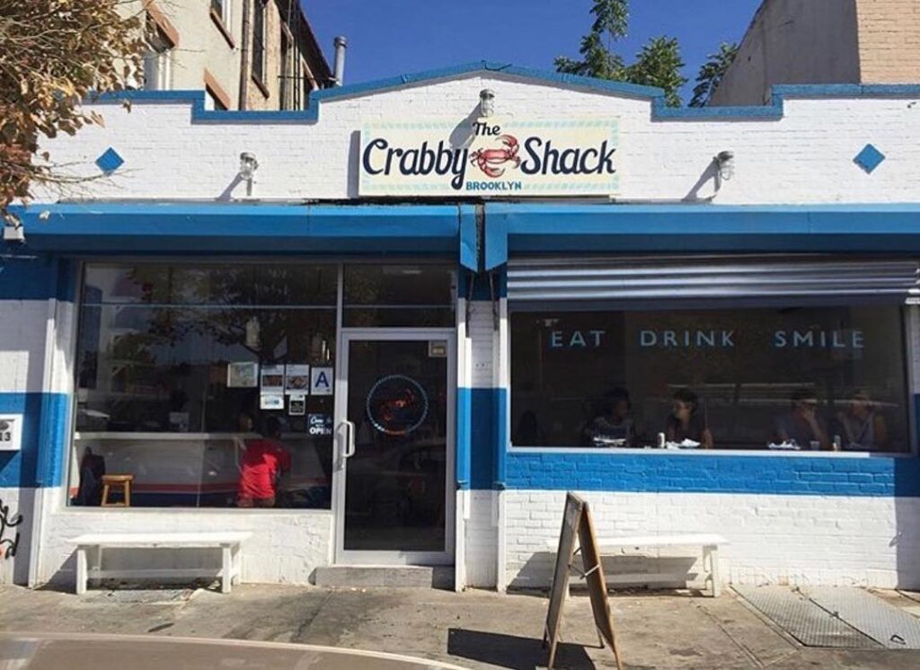 Exterior view of restaurant painted blue and white at The Crabby Shack
