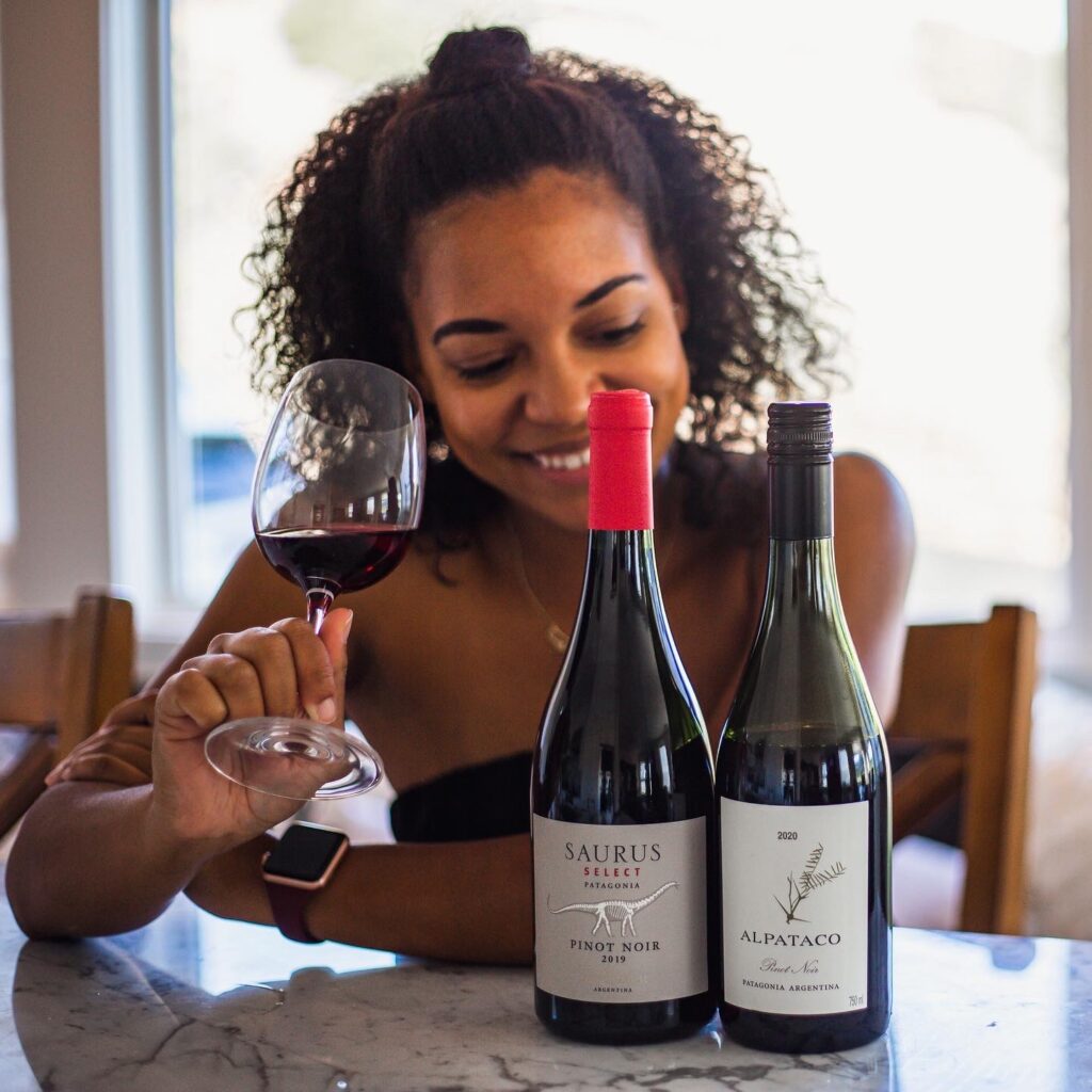 Black woman enjoys wine, sommelier, Lindsay Perry