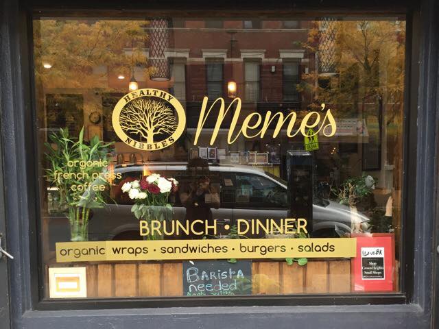 The Meme's name and logo painted on a glass window at Meme's Healthy Nibbles