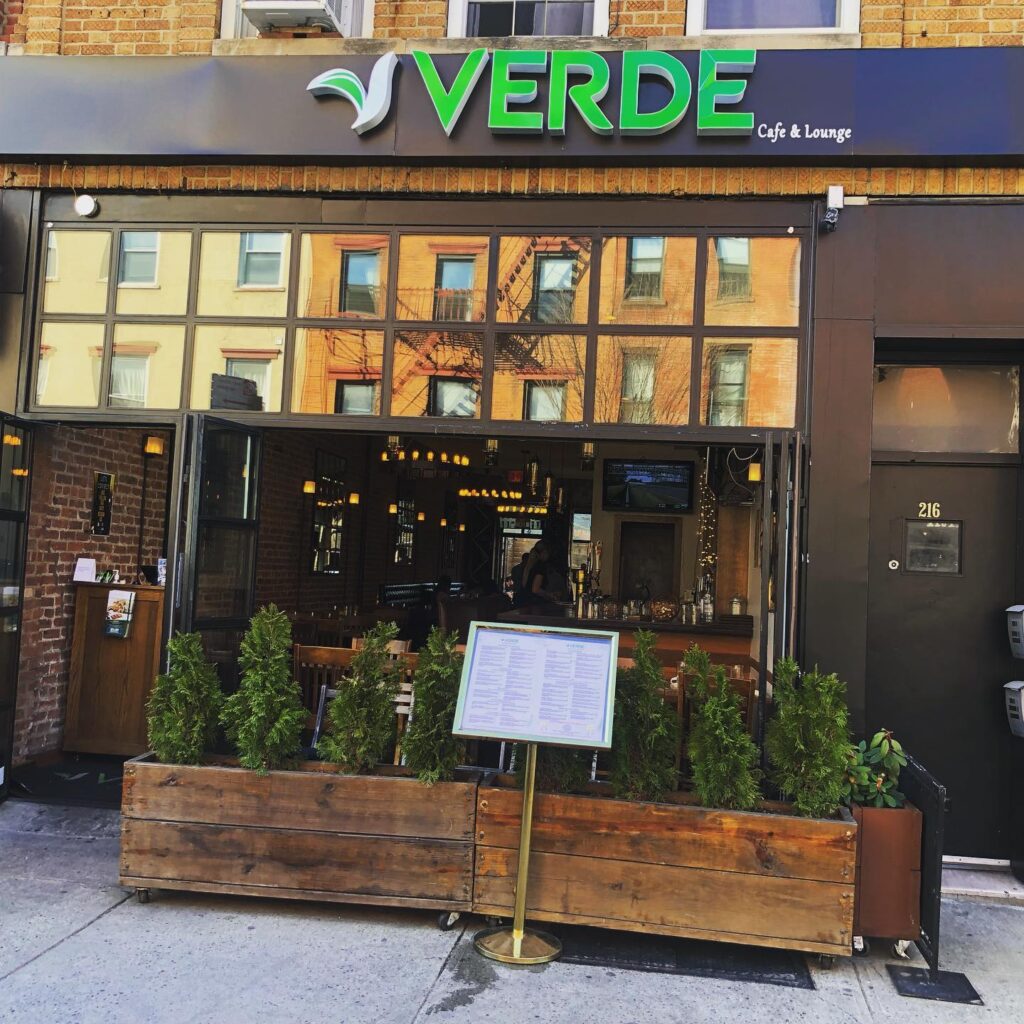 Front of restaurant with plants on sidewalk at Verde on Smith